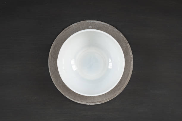 white plate on concrete plate on dark wooden background