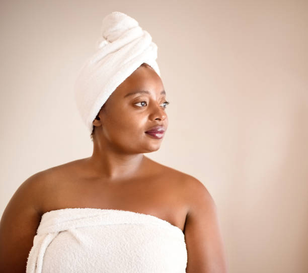 istock Female with towel wrapped on her head against grey background. 1096367168