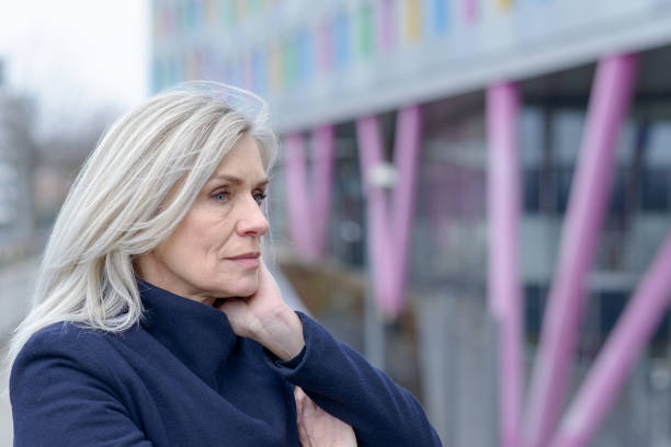istock Pensive woman standing staring into the distance 1096380254