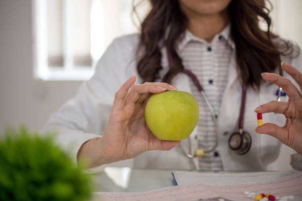 istock Female doctor working at office desk and smiling at camera, office interior 1096382524
