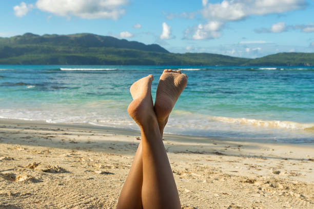 istock Female legs on the tropical beach. Relax in vacation. 1096387258