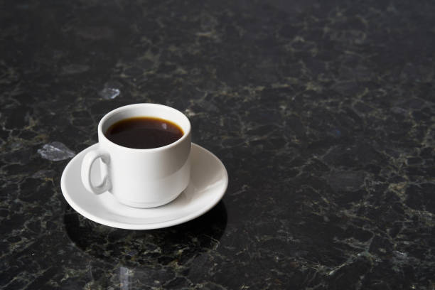 istock White cup of esoresso on granite table surface, copy space 1096419644