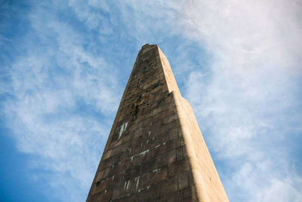 istock Old stone obelisk from red bricks standing in the summer day. Blue sky with white clouds. Monument of memory and glory. No war concept. Peaceful message. 1096421122