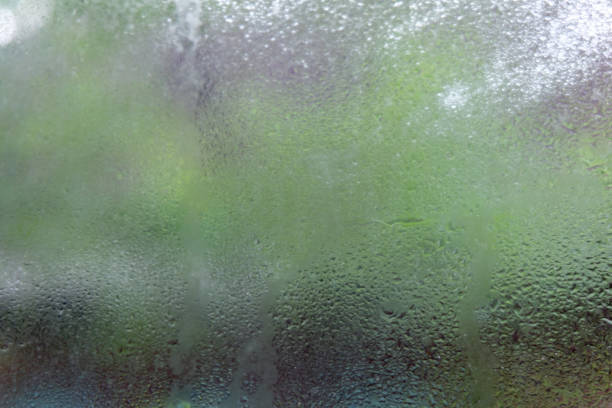 Water drops or rain droplet on the glass on blurred with backgrounds. stock photo