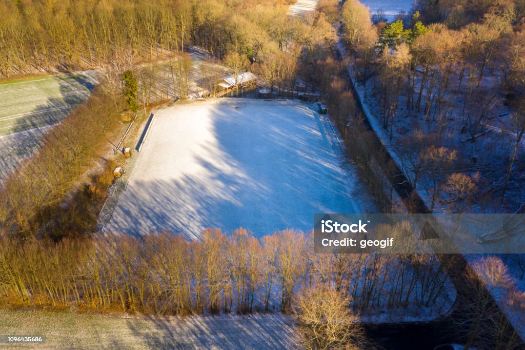 Aerial view of a football field of a district league team in a village with the first snow of the year Aerial view of a football field of a district league team in a village with the first snow of the year, drone shot Accessibility Stock Photo