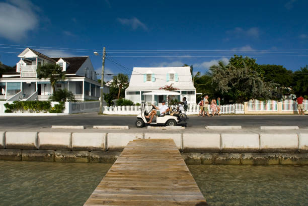 Bahamas Golf car and loyalist home. Bay Street. Dunmore Town, Harbour Island, Eleuthera. Bahamas dunmore town stock pictures, royalty-free photos & images