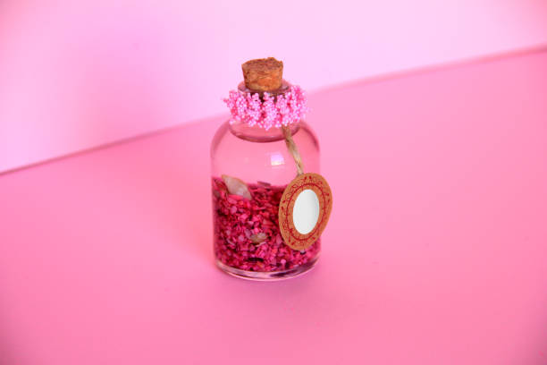 istock Alchemy and aromatherapy pink background and glass bottle 1096443926
