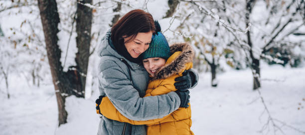 istock Mother embracing daughter on a snow 1096452280