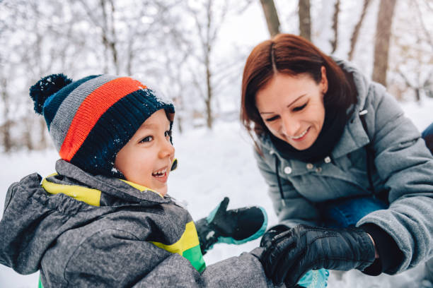 istock Mother and son playing in the snow 1096452950