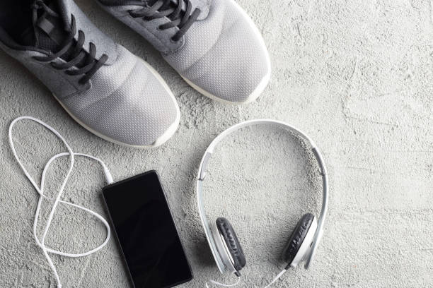 Flat lay lifestyle composition. Sneakers, smartphone and headphones