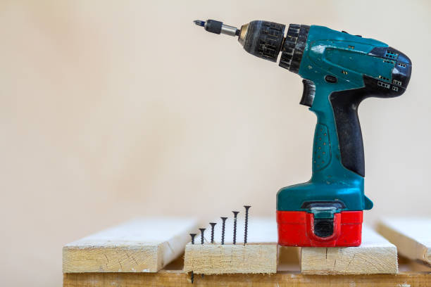 istock Electric cordless screwdriver and some screws close-up 1096458596