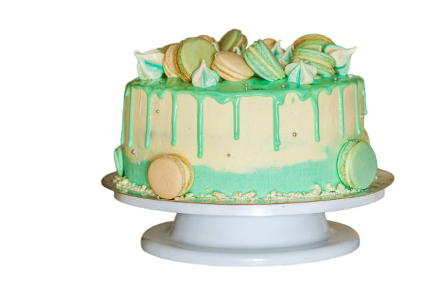 istock Sweet creamy green cake with macaroons on top isolated on white 1096458776