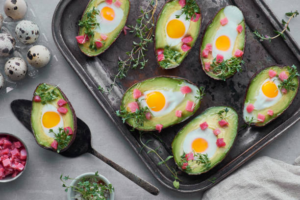 istock Keto diet dish: Avocado boats with ham cubes, quail eggs and cress sprout 1096461306