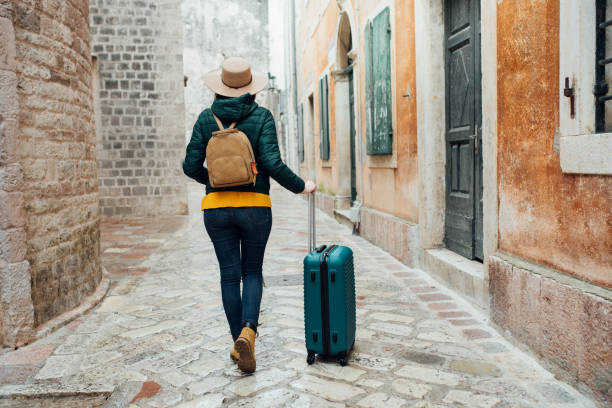 istock Woman standing by her luggage 1096463846