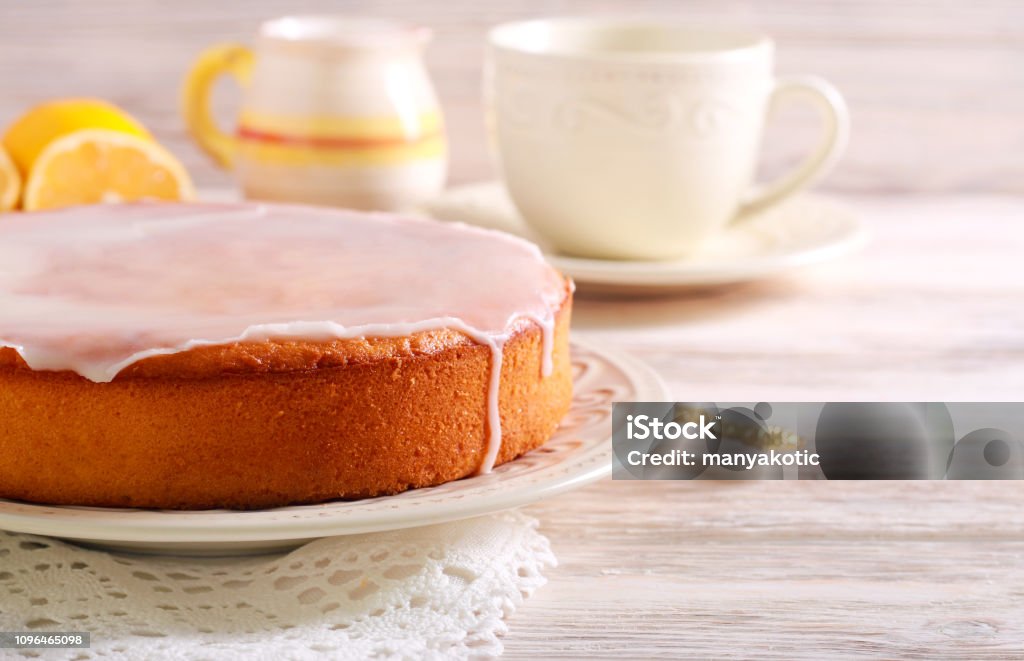 Lemon and yogurt cake with icing Lemon and yogurt cake with icing on plate Cake Stock Photo