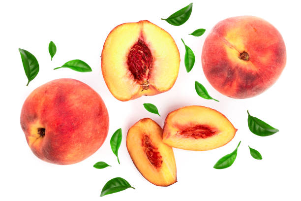 istock ripe peaches with leaves isolated on white background. Top view. Flat lay pattern 1096477886