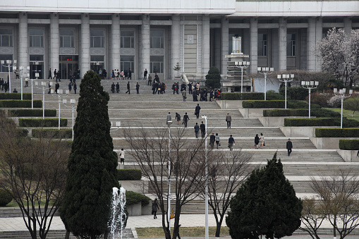 April 13, 2018. Pyongyang, North Korea.\nStairs of Grand People's Study House and Great Library. \nGrand People’s Study House is one of the most famous buildings in Pyongyang and part of pretty much every tour to North Korea. North Korea’s central library is located at Kim Il-sung Square in the heart of Pyongyang and can hold up to 30 million books, including a couple of foreign ones. It was built in a traditional Korean style over a period of 21 months and opened in April of 1982 to honor Kim Il-sung’s 70th birthday.