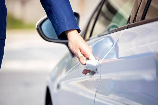 istock Young businessman opening white car door. 1096482232