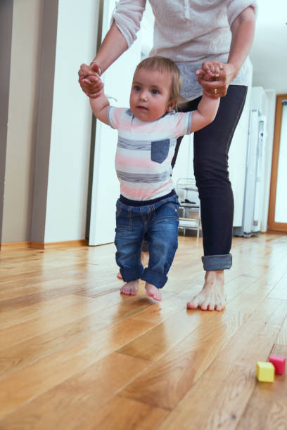 istock Mother teaching her boy to walk 1096484468