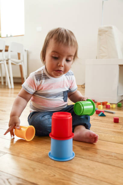 istock Little boy building tower on the floor 1096484506