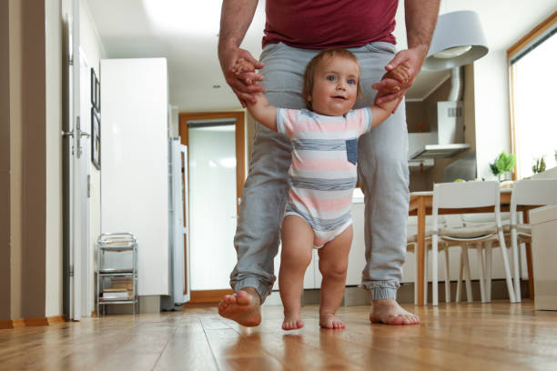 istock Father teaching his boy to walk 1096484516