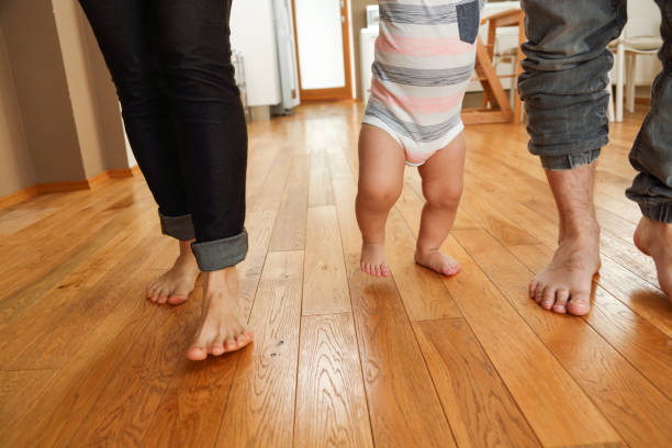 istock Parents teaching their child to walk 1096484590