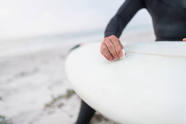 istock Close up of a surfer waxing his board before going surfing 1096487370