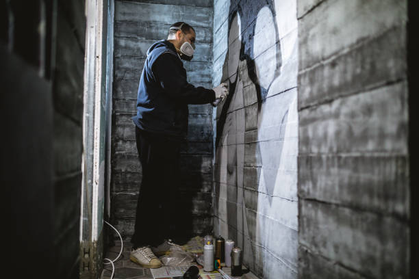 istock Graffiti artist making a graffiti on the wall indoors 1096490672
