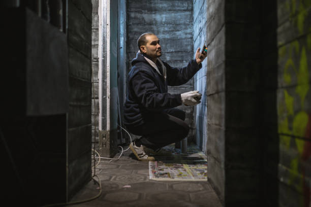 istock Young artist drawing graffiti on the wall 1096491266