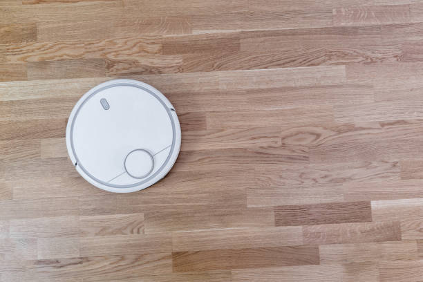 istock smart home Robot vacuum cleaner on laminate floor, efficient dust absorption, automatic intelligent cleaning algorithm selection system 1096509604