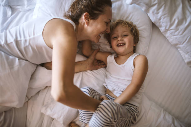 istock Mother and son having fun together in the bedroom 1096512314