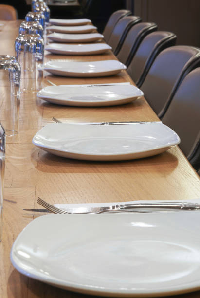 istock Plates and glasses lined up on table in a restaurant 1096514602