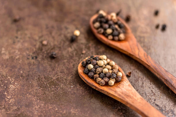 istock Peppercorns on Wooden Spoons 1096529978