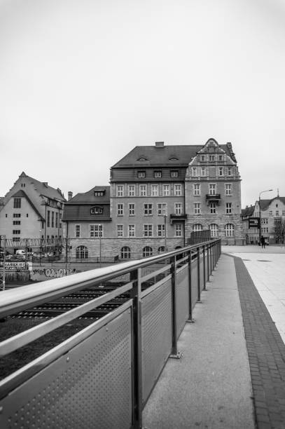 Poznan, Poland - November 21, 2018: Metal barrier next to a sidewalk leading the the Adam Mickiewicz University of Economics building on the Swiety Marcin street in the city center on a cloudy day.