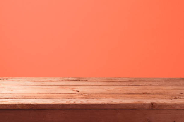 istock Empty wooden table with over abstract coral color wall background. 1096534810