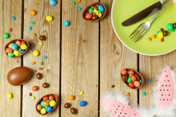 istock Easter holiday background with chocolate eggs, plate and bunny ears. Top view from above. Flat lay 1096534832