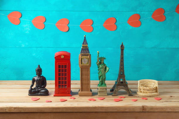 Travel and tourism background with souvenirs from around the world. Travel and tourism background with souvenirs from around the world on wooden table. Romantic valentine's day trip concept. souvenir stock pictures, royalty-free photos & images