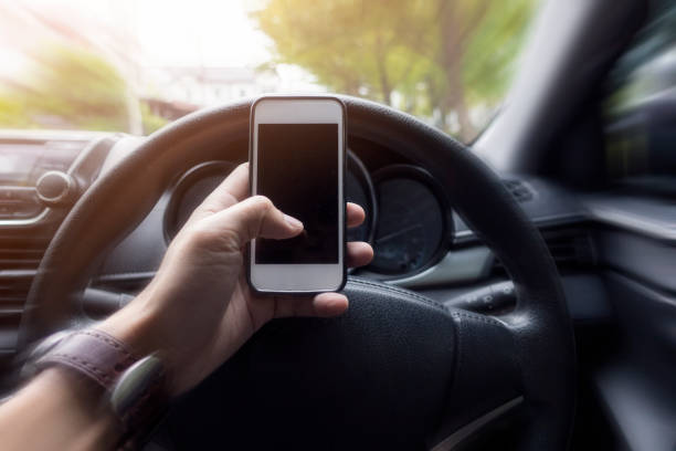 istock Close up man hand using smart phone while  he is driving the car 1096536810