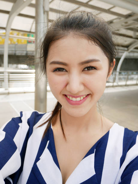 Beautiful woman take photo selfie and traveling in the city. stock photo