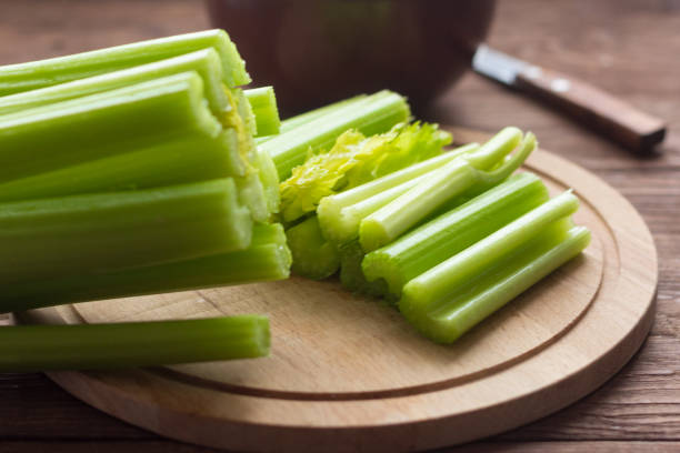 istock fresh celery, celery stalks close up on wooden background 1096537412