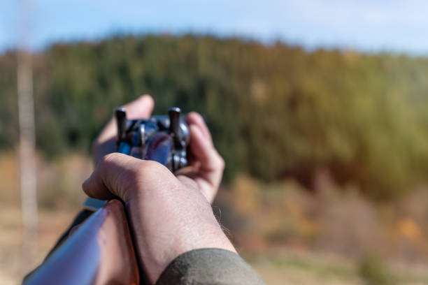 istock Hunter with retro shotgun aims at the target. Hunting season 1096539258
