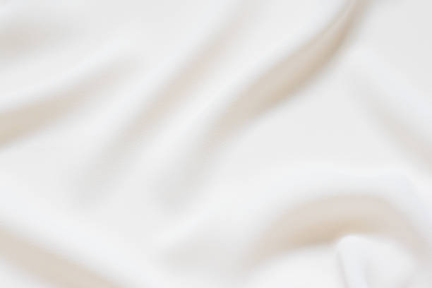 istock Matte cream delicate soft pleated fabric background. Smooth elegant luxury cloth texture. Gentle pastel color wedding background 1096545764