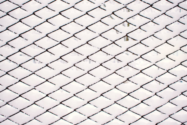 istock Abstract Snow winter pattern, background. Metal grid with white sticking snow 1096547572