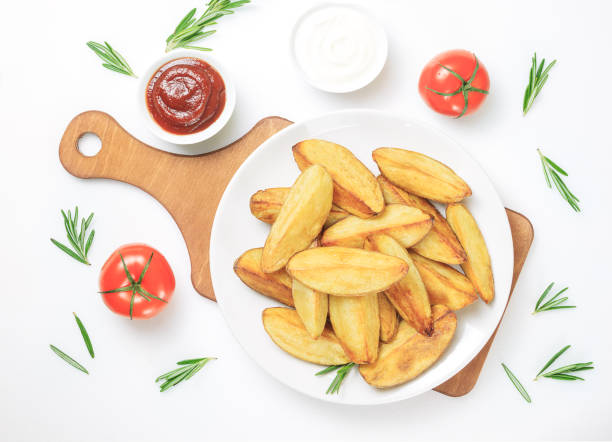 spicchi di patate fritte - roasted potatoes prepared potato herb food foto e immagini stock