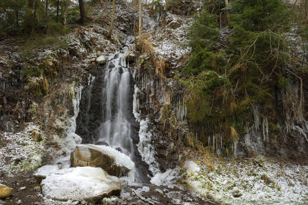 istock Icy waterfall in the frosty forest with snow 1096548370