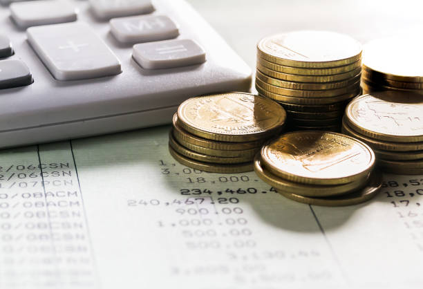 istock Gold coins with calculator on book bank 1096553040