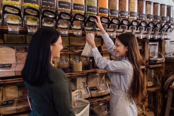 Shop assistant helping customer in packaging free shop. stock photo