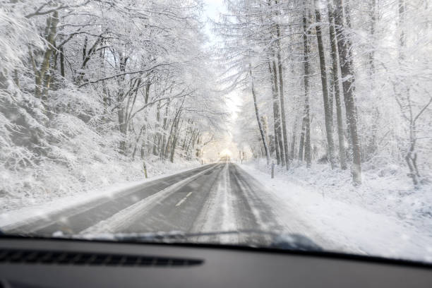 istock view through the windscreen when driving dangerously on a slippery forest road in the snow, copy space 1096558848
