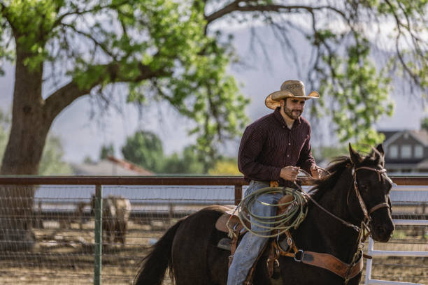 istock A cowboy horseback riding on a ranch. 1096564228