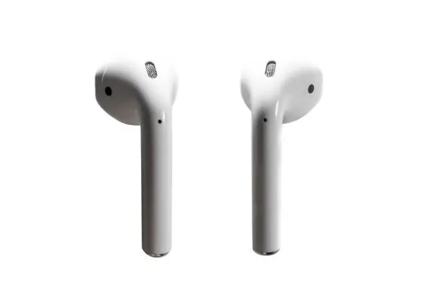 Minimalist closeup of wireless earphones headphones on plain white background